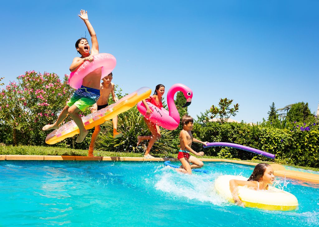 kids jumping into pool for party rental